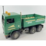 A 1:16 scale hard plastic green Volvo tipper truck with GRC decals, by Bruder.