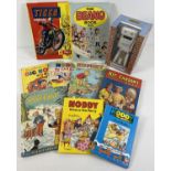 A boxed Confused.com Brian the robot toy together with a collection of assorted books and annuals to