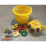 A yellow carry tub of assorted vintage plastic toys. To include Bluebird Toys Big Yellow Teapot with