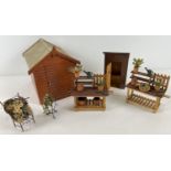 A collection of 1:12 scale dolls house garden buildings and accessories. To include garden shed,