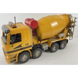 A 1:16 scale Mercedes 8 wheel yellow cement truck by Bruder with GRC decals. Moving parts