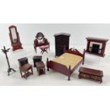 A collection of dark wood 1:12 scale dolls house bedroom furniture. To include double bed, wardrobe,