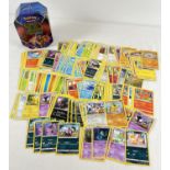 200 assorted PokÃ©mon cards in a Galar Legend Zacian PokÃ©mon V trading card game tin.