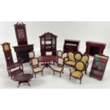 A collection of 1:12 scale dark wood dolls house furniture. To include mirror backed bookcase, piano