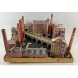 A collection of cardboard kit model railway/model vehicle buildings. To include factories, houses