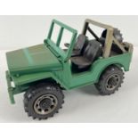 A 1:16 scale hard green and grey plastic open back jeep with lift up bonnet, by Bruder.