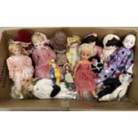 A collection of 12 porcelain dolls to include Pierrot dolls. Together with a vintage vinyl doll with