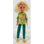 A Vintage 1974 - 76 Sindy doll with blonde hair. In a floral V back top, green trousers and yellow