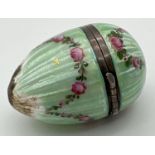 A 935 silver and green guilloche egg shaped trinket with floral swag detail. Hinged lid has interior