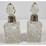 A small pair of antique cut glass scent bottles with silver collars. Hallmarked London 1923. Approx.