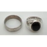 2 vintage silver rings. A plain band ring and a signet ring set with an oval of black onyx. Sizes