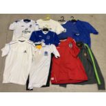 A collection of assorted football shirts and sports clothing. To include Everton FC t shirts,