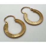 A pair of vintage hoop earrings with sun-ray decoration to both sides. Hallmarks to posts. Total
