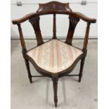 A Victorian dark wood corner chair with carved detail to back and fanned spindle design. Turned legs