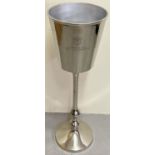 A large polished aluminium Bollinger Champagne cooler on a freestanding pedestal stand. Approx. 81cm