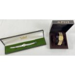 2 vintage ladies wristwatches in original boxes. A Fuji 17 jewels gold tone watch with stone set