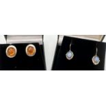 2 pairs of modern design silver earrings. A pair of oval stud earrings set with a cabochon of