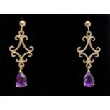 A pair of 9ct gold open work scroll detail drop style earrings each set with a teardrop cut amethyst