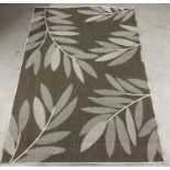 A modern reversible rug with foliate design in neutral tones. Approx. 222cm x 160cm.