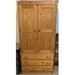 A vintage pine double door wardrobe with 3 lower drawers. Interior hanging rail and hooks. Approx.