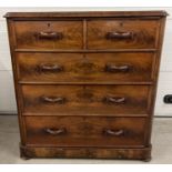 An antique wood 2 over 3 chest of drawers with decorative wooden looped handles. Raised on bun feet,