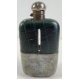 An antique silver plated and green leather covered hip flask. Hinged lid has twist lock feature.