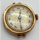 An Antique 9ct gold cased wristwatch with fleur de lis decoration to face. Denting and splits to