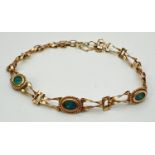 A 9ct gold decorative link bracelet with set 3 oval cut opal stones in bezel set mounts. With rope
