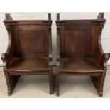 A pair of antique dark oak church sideman's pew chairs. With panelled backs and shaped arms. Each