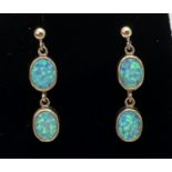 A pair of opal set double drop style earrings. Each earring set with two oval cut opals. Approx. 3cm