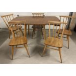 A mid century blond Ercol drop leaf dining table with 5 Ercol chairs. Rectangular shaped extending