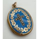 An antique 9ct gold front and back locket with blue enamel and cross design, set with seed pearls to