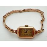 A ladies 9ct gold vintage 15 jewels Swiss made wristwatch. Rectangular shaped case with expanding