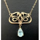 An Art Nouveau style 9ct gold and blue topaz necklace. Open work panel with tulip flower detail on a