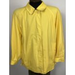 A ladies Burberrys yellow lightweight jacket. Front zip fastening with button cuffs and side