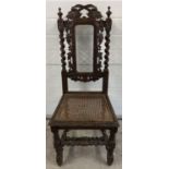 An antique dark wood hall chair with barley twist columns and carved vine leaf detail. With loose