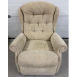 A modern T Motion electric recliner armchair with cream coloured floral upholstery. Complete with