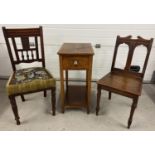 3 antique dark wood items of furniture. 2 Victorian hall chairs with carved detail together with