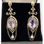 A pair of 9ct gold chandelier style drop earrings each set with an oval cut Rose De France amethyst,