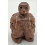 A carved wooden netsuke of monkeys and an octopus. Toggle holes to underside. Approx. 4.5cm tall.
