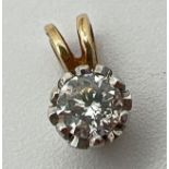 A 9ct gold single 0.33ct diamond set pendant. Pierced white gold mount on a yellow gold bale.