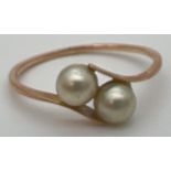 A vintage 9ct gold ring with 2 tension set pearls in a twist design setting. Stamped 9ct to