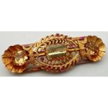 A vintage 24ct yellow gold brooch set with 3 large yellow topaz stones and small ruby cabochons. A