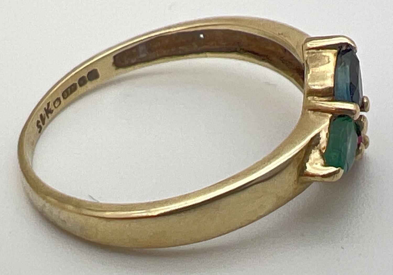 A 9ct yellow gold multi stone trinity ring with a pear cut emerald, sapphire & ruby in a 3 point - Image 2 of 4