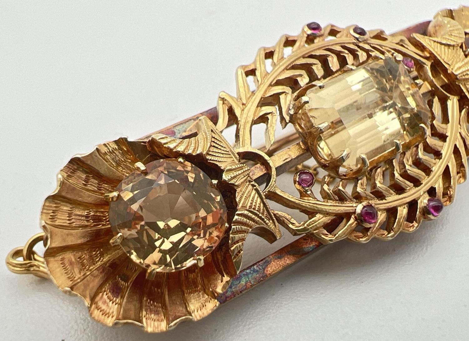 A vintage 24ct yellow gold brooch set with 3 large yellow topaz stones and small ruby cabochons. A - Image 2 of 5