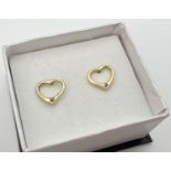 A pair of silver gilt open heart shaped stud earrings, each set with a small diamond. Reverse of