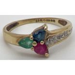 A 9ct yellow gold multi stone trinity ring with a pear cut emerald, sapphire & ruby in a 3 point