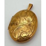 A 9ct gold oval shaped locket with engraved scroll & foliate design to front. Fully hallmarked to