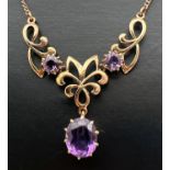 A 9ct gold and amethyst fixed pendant necklace. A 3 sectional pendant set with 3 large amethyst