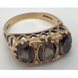 A vintage 9ct gold an smoked quartz trilogy ring with a high mount setting of pierced heart